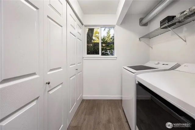a utility room with cabinets washer and dryer