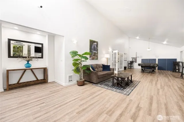 a living room with furniture and a wooden floor