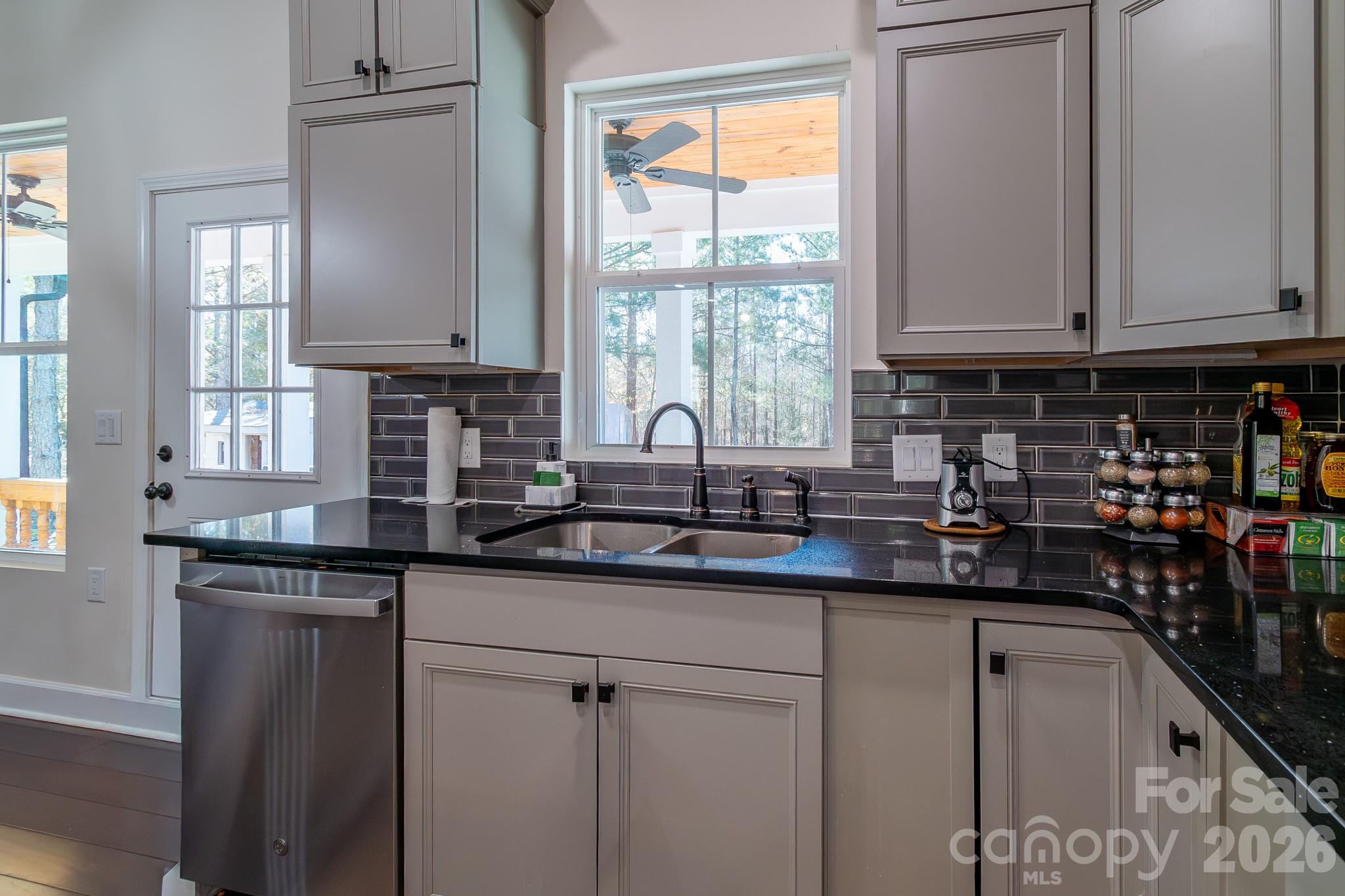 2038 Billy Jordan Road Pageland, SC 29728 - Photo 18 of 45 a kitchen with stainless steel appliances granite countertop a sink a window and cabinets