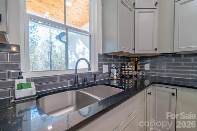 a kitchen with granite countertop a sink and a window