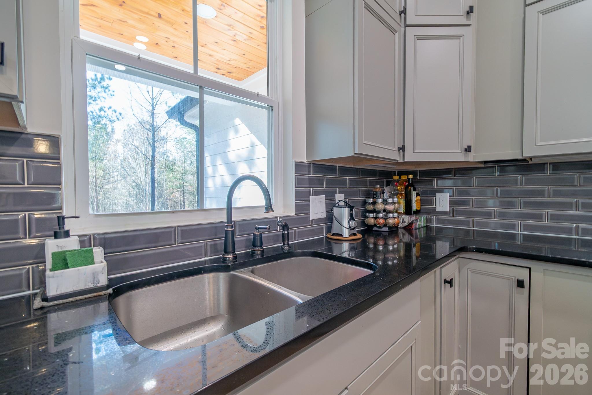 2038 Billy Jordan Road Pageland, SC 29728 - Photo 19 of 45 a kitchen with granite countertop a sink and a window