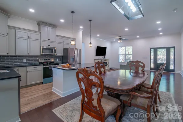 a kitchen with kitchen island granite countertop a table and chairs