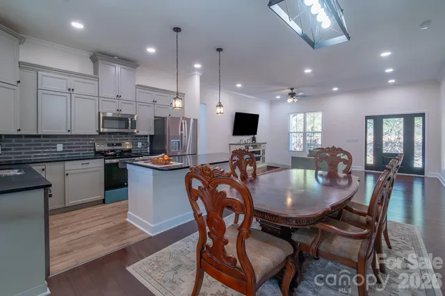 a kitchen with kitchen island granite countertop a table and chairs
