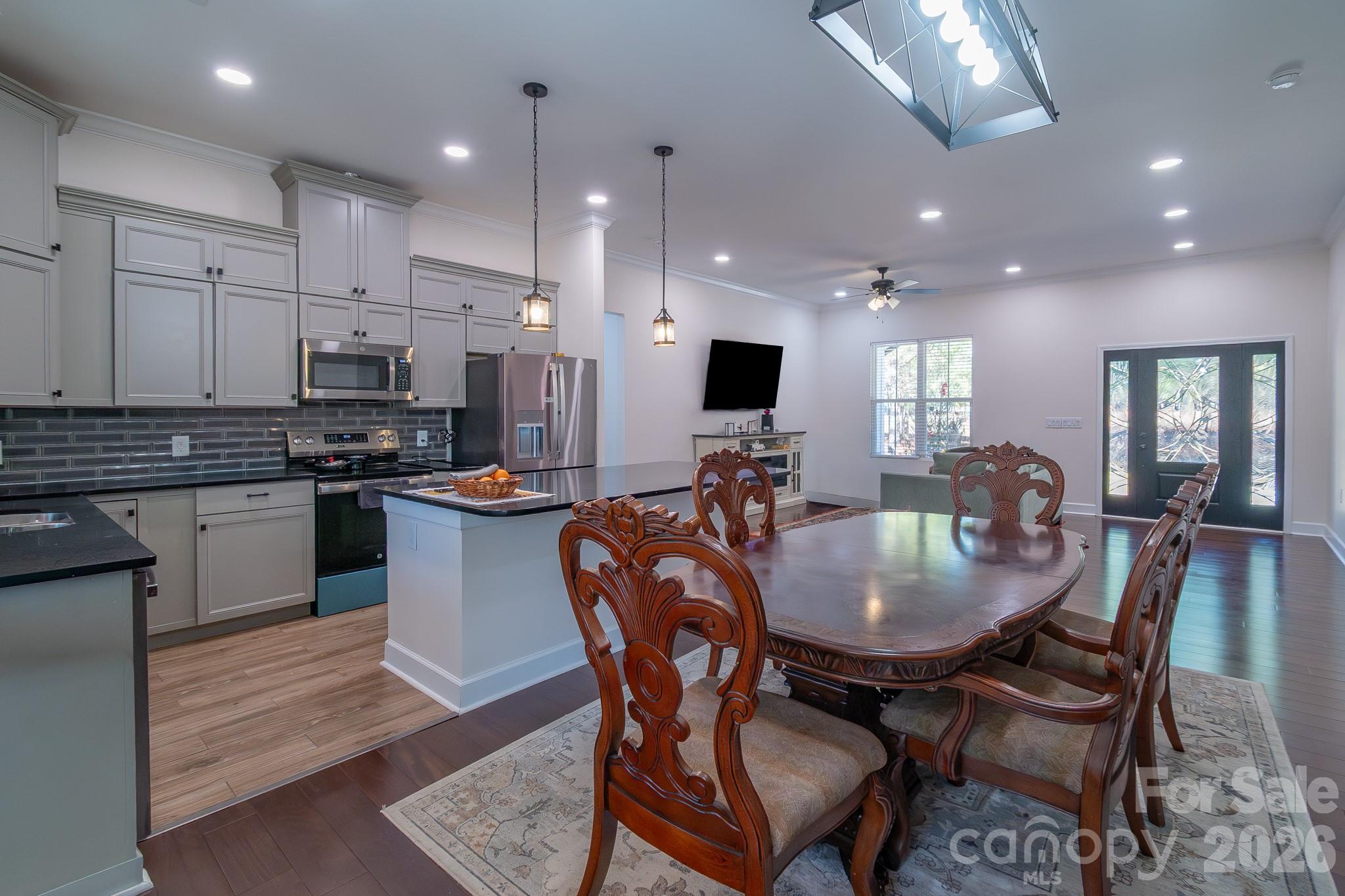 2038 Billy Jordan Road Pageland, SC 29728 - Photo 23 of 45 a kitchen with kitchen island granite countertop a table and chairs
