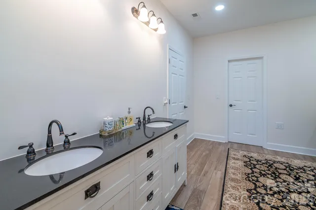 a bathroom with a double vanity sink and mirror