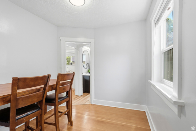 210 North 200 West Logan, UT 84321 - Photo 12 of 31 Light-filled interior space featuring wood-finish flooring, crisp white walls, and a recessed ceiling light fixture