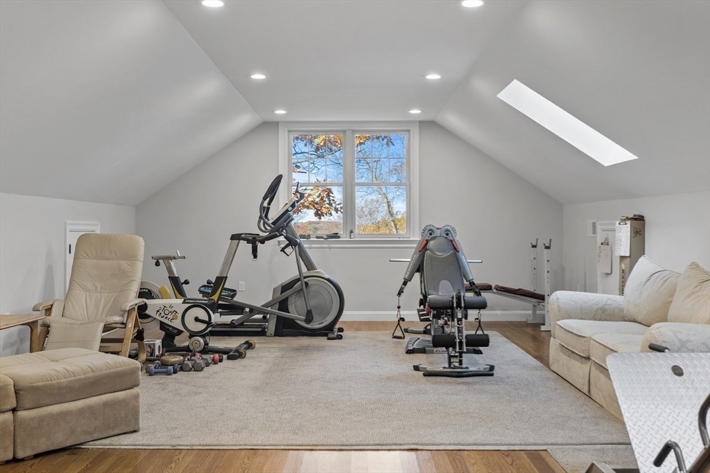 217 Hillcrest Road Needham, MA 02492 - Photo 16 of 17 a room with gym equipment and a large mirror