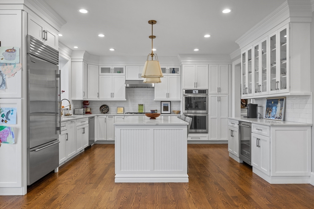 217 Hillcrest Road Needham, MA 02492 - Photo 7 of 17 a kitchen with white cabinets and stainless steel appliances
