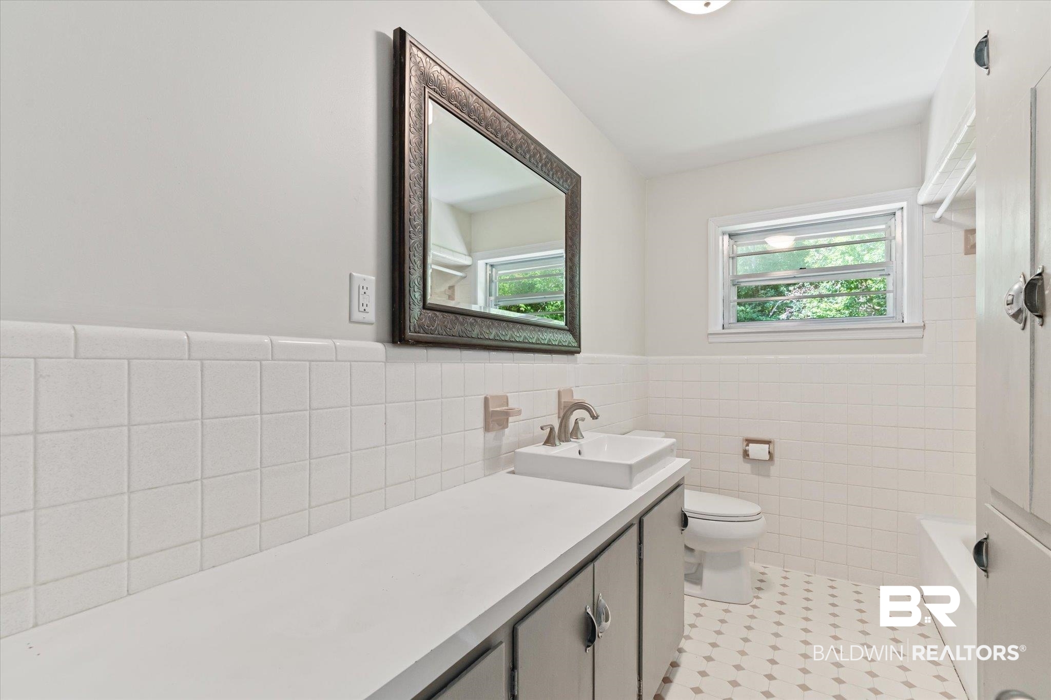 3325 Lacoste Road Mobile, AL 36618 - Photo 13 of 35 Bathroom with toilet, vanity, tile patterned flooring, and tile walls