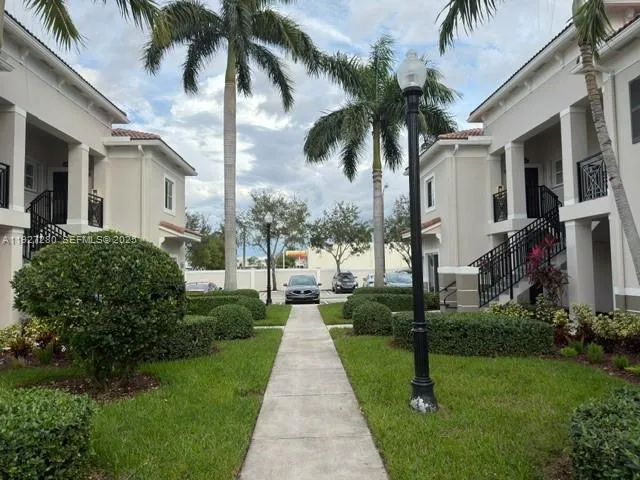 a front view of a house with a garden and yard