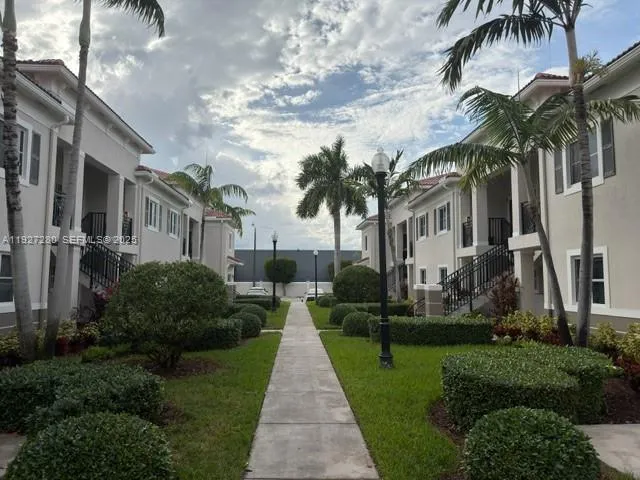 a front view of a house with a garden and plants
