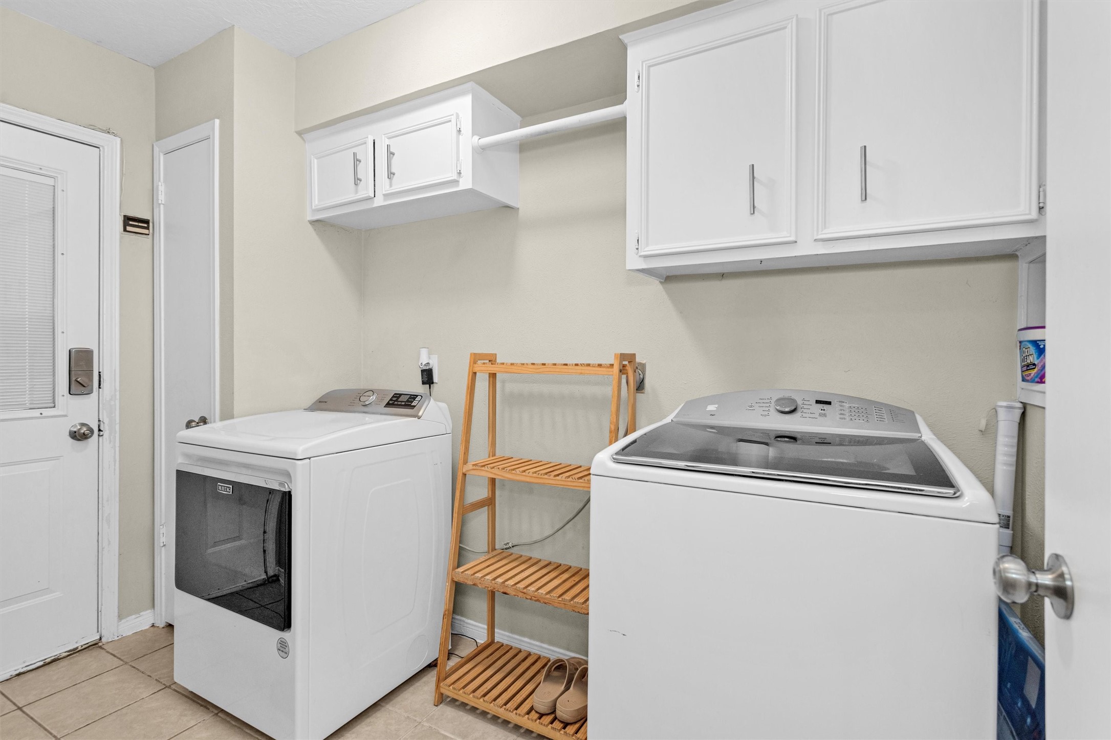 2005 Tickner Street Conroe, TX 77301 - Photo 14 of 50 Large utility room with built-in cabinetry, a convenient closet, and a back door providing easy access to the backyard and detached garage.