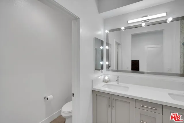 a bathroom with a double vanity sink mirror and shower