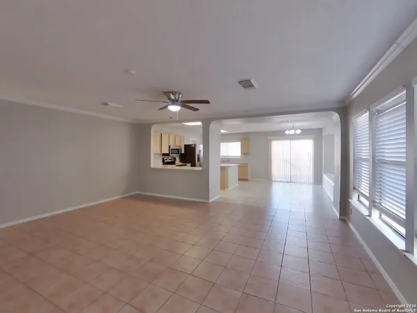 en empty room with windows and fireplace