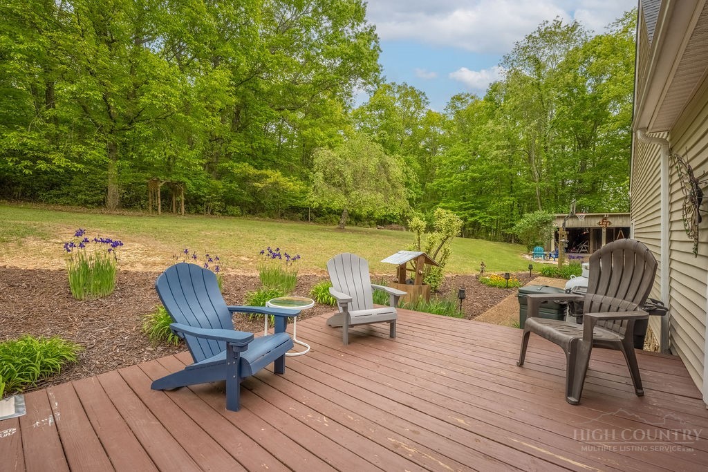 970 Vox Road Sparta, NC 28675 - Photo 12 of 50 a view of deck with table and chairs and wooden floor