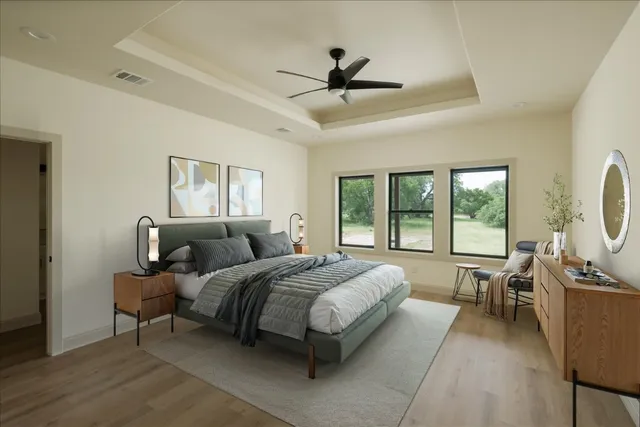 a bed room with a bed and large windows