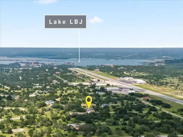 a front view of a house with a garden and tree