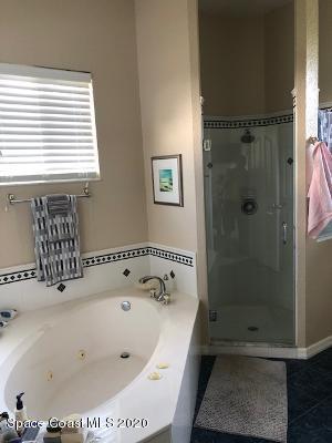 4635 Seminole Trail Merritt Island, FL 32953 - Photo 14 of 31 a bathroom with a bathtub and shower