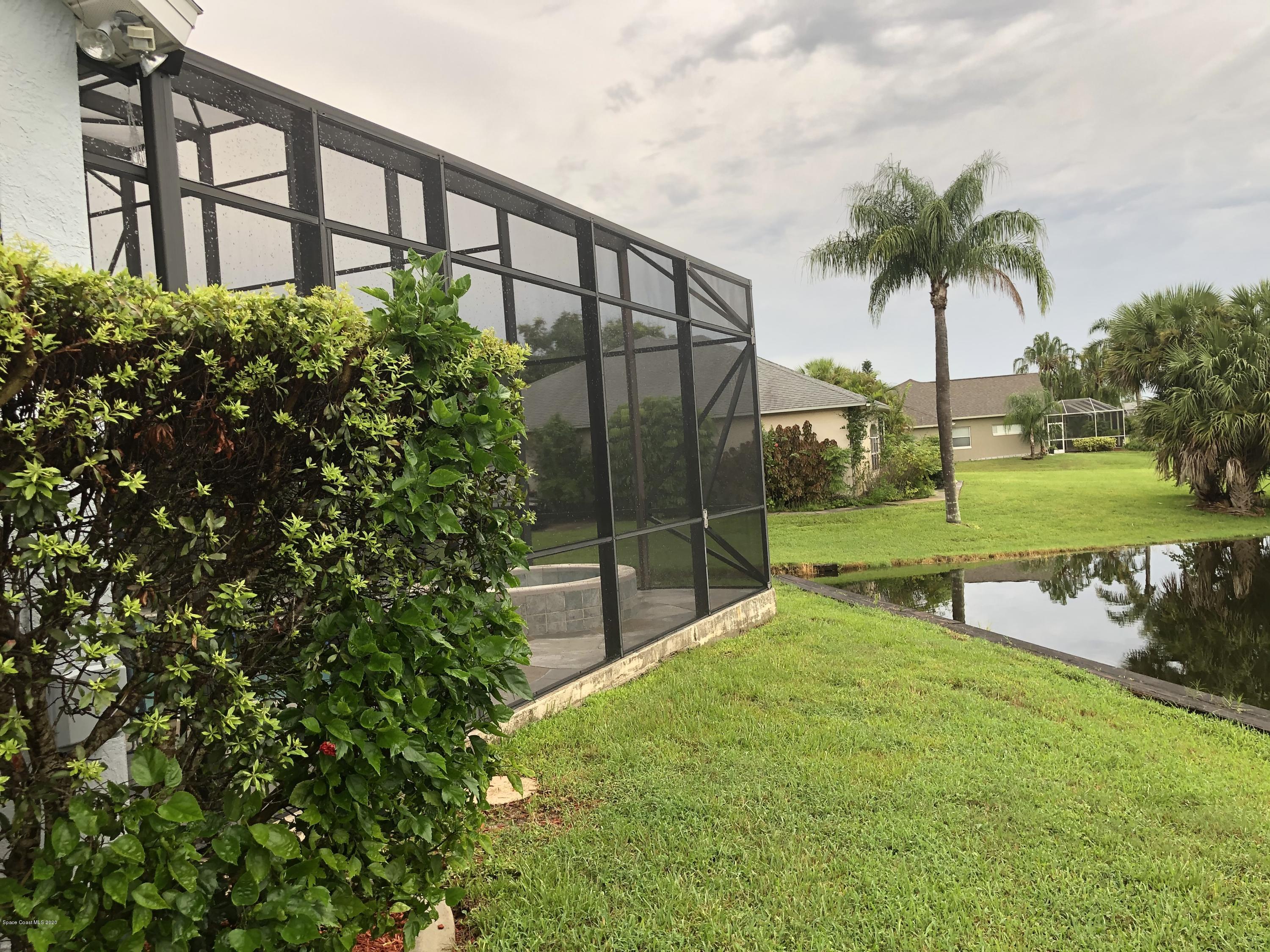 4635 Seminole Trail Merritt Island, FL 32953 - Photo 29 of 31 a view of a swimming pool with a garden and trees