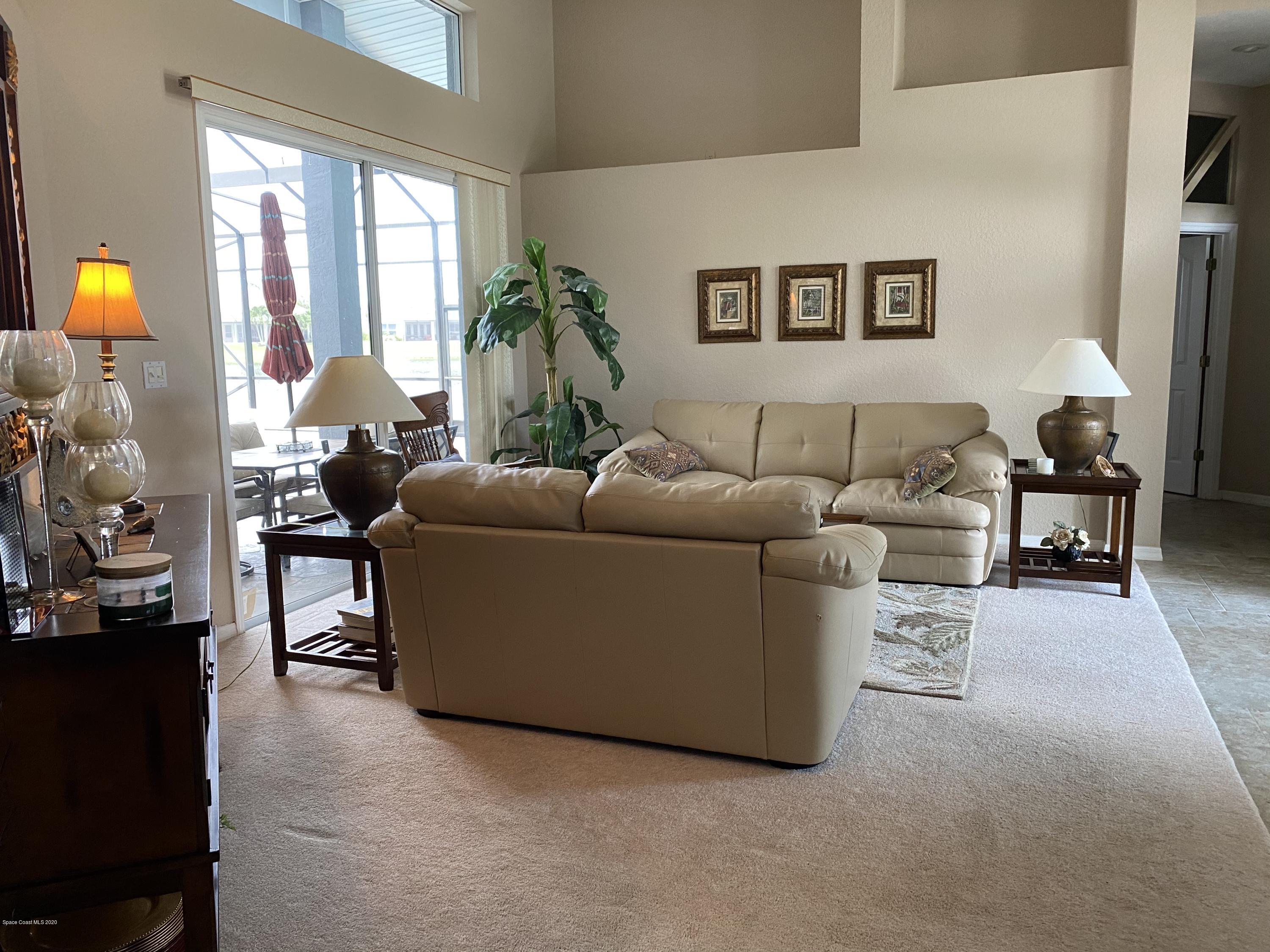 4635 Seminole Trail Merritt Island, FL 32953 - Photo 4 of 31 a living room with furniture and a lamp