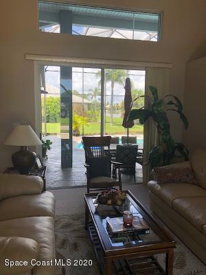 4635 Seminole Trail Merritt Island, FL 32953 - Photo 5 of 31 a living room with furniture and a floor to ceiling window