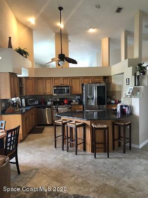 4635 Seminole Trail Merritt Island, FL 32953 - Photo 6 of 31 a view of a kitchen with kitchen island stainless steel appliances dining table and chairs