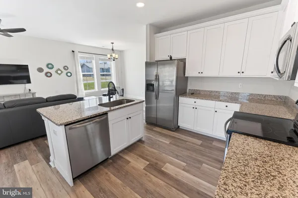 a kitchen with a sink stove and refrigerator