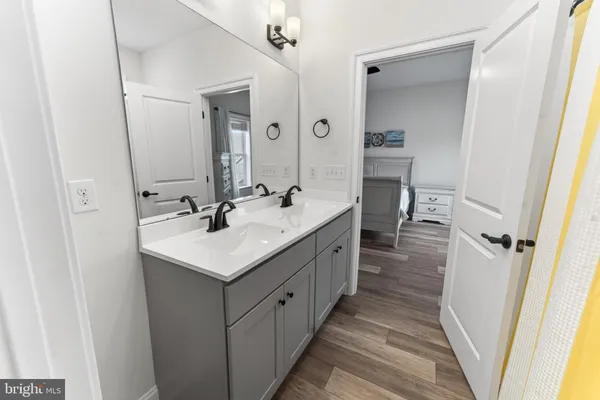 a bathroom with a sink double vanity and a mirror