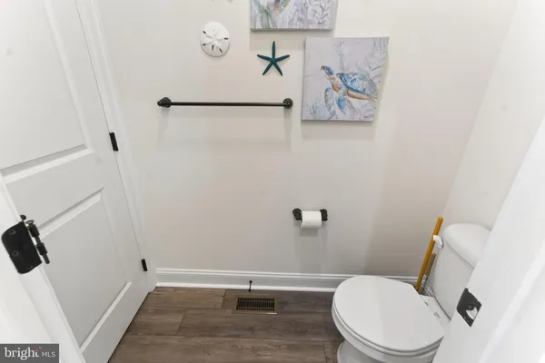 a white toilet sitting next to a bath tub