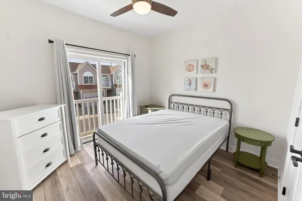 a view of a bedroom with furniture and wooden floor