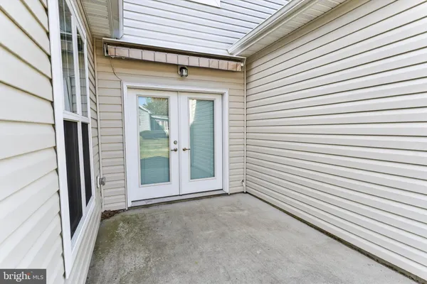 a view of a porch with a door and a large window