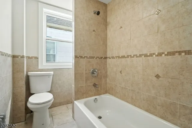 a bathroom with a bathtub and toilet