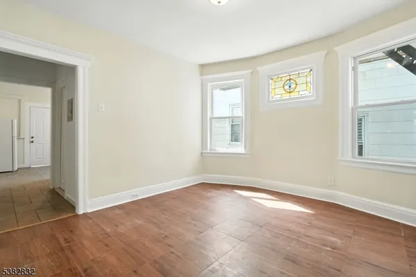 an empty room with windows and closet