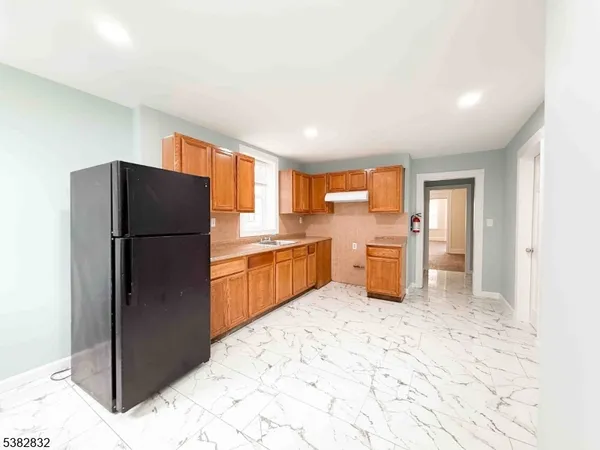 a kitchen with stainless steel appliances a refrigerator and a sink