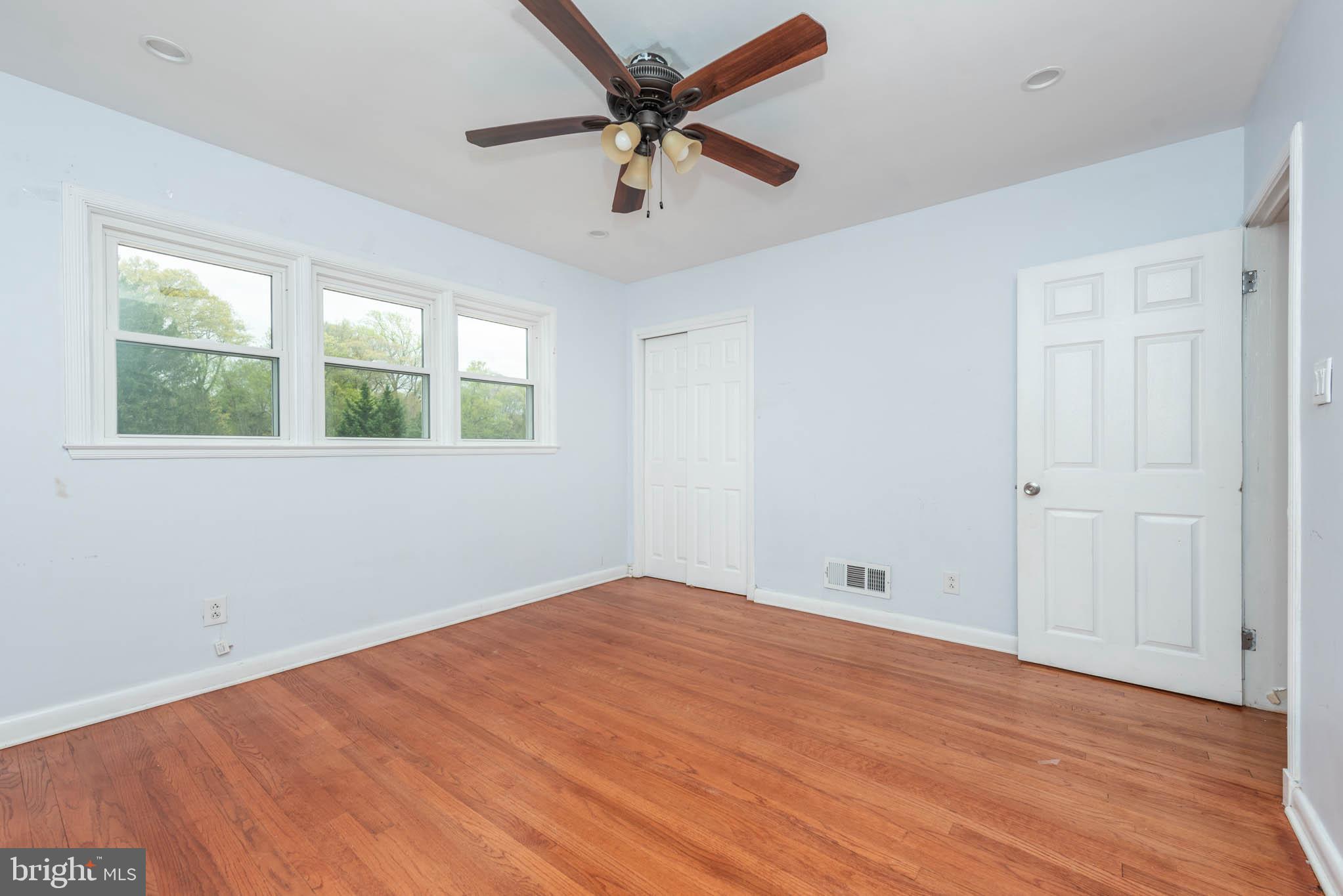 6702 Queens Ferry Road Baltimore, MD 21239 - Photo 12 of 40 wooden floor in an empty room with a window