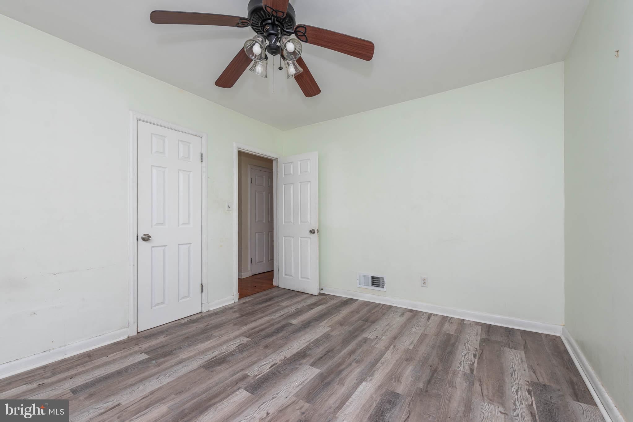6702 Queens Ferry Road Baltimore, MD 21239 - Photo 16 of 40 wooden floor in an empty room