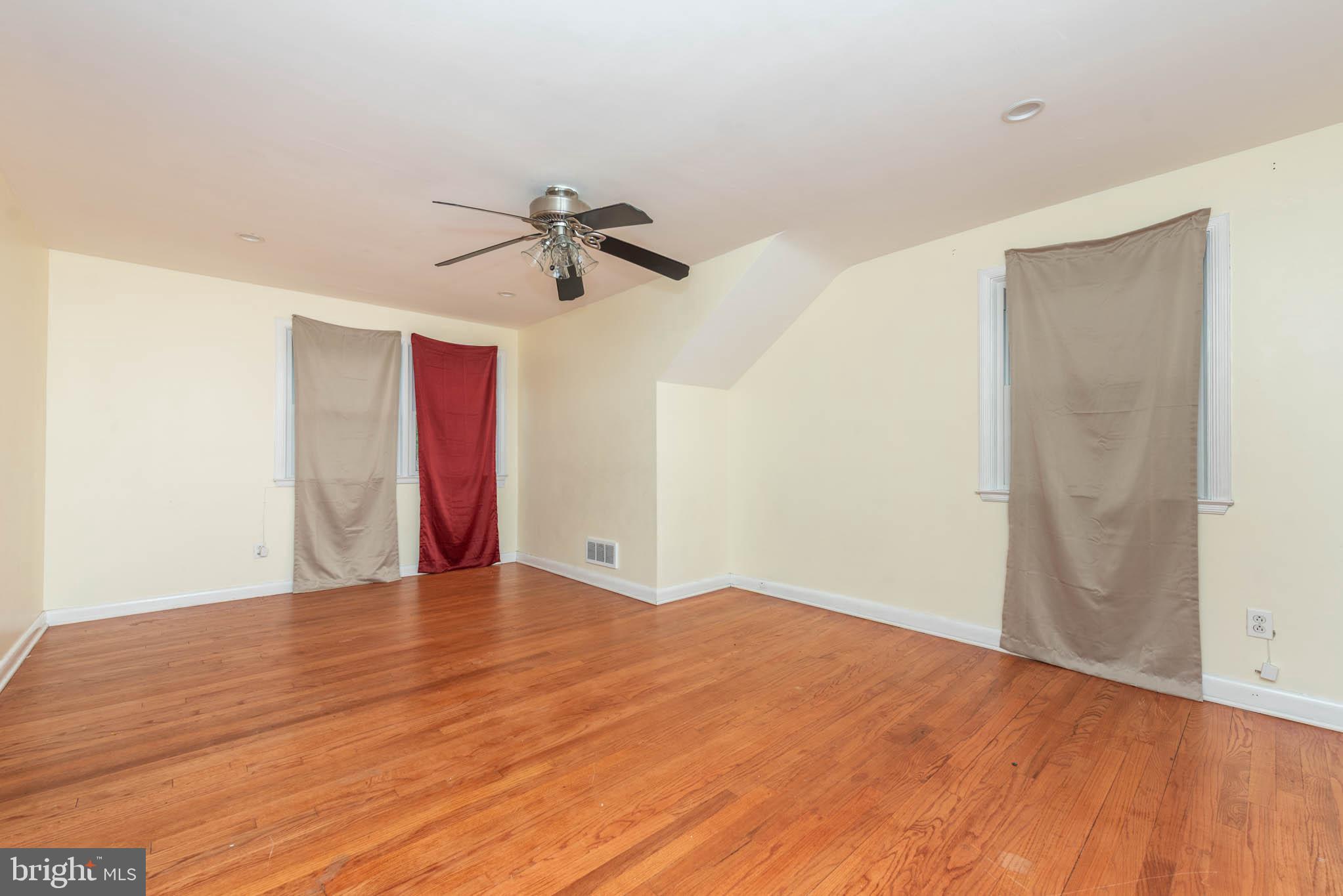6702 Queens Ferry Road Baltimore, MD 21239 - Photo 18 of 40 a view of empty room with wooden floor