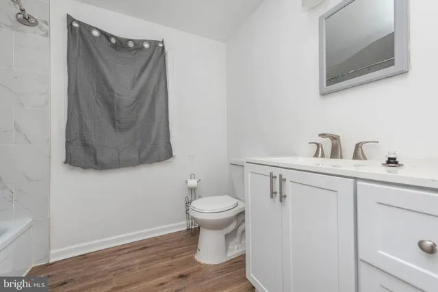 a bathroom with a toilet sink and mirror