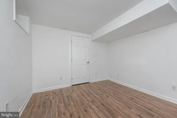 a view of room with wooden floor