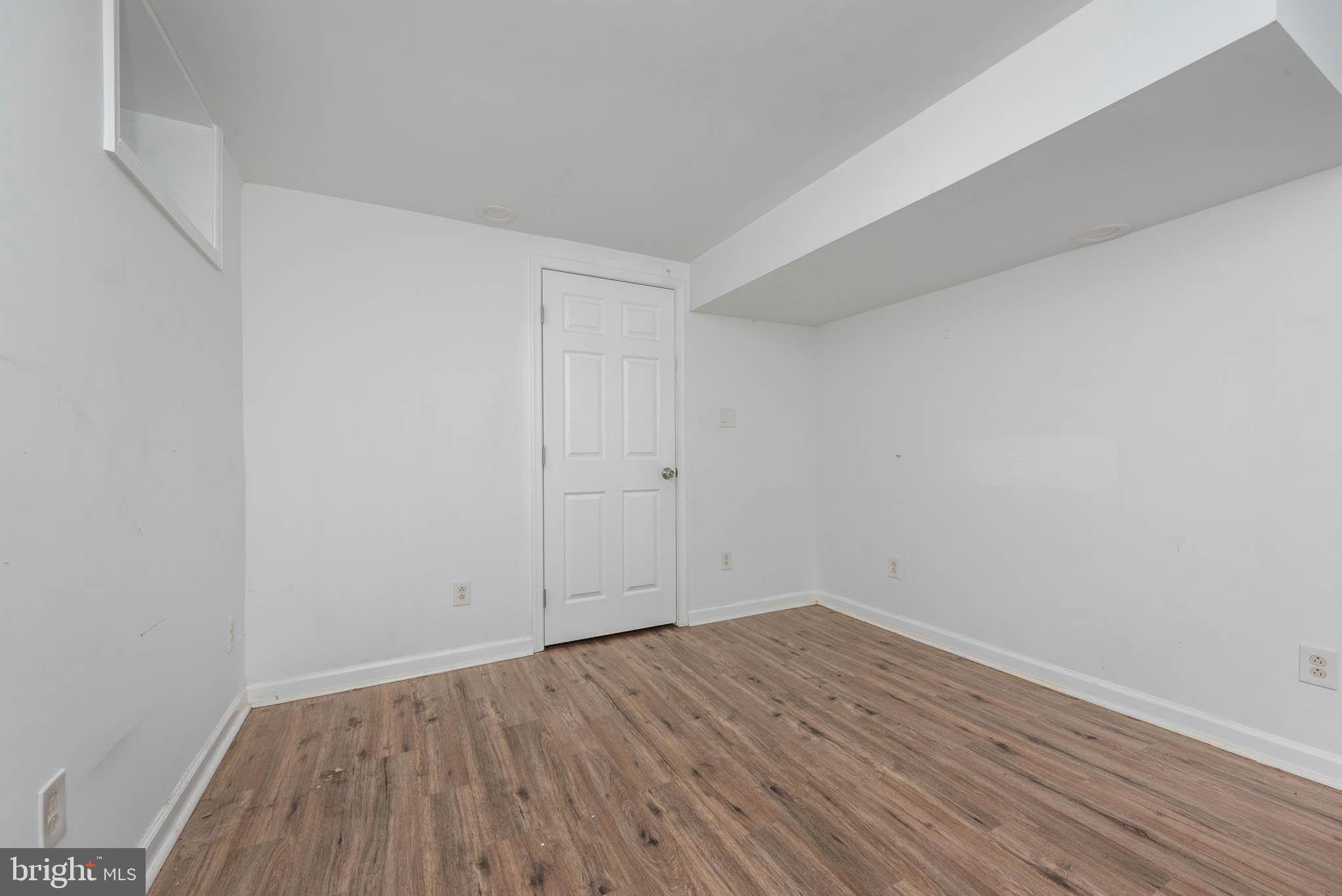 6702 Queens Ferry Road Baltimore, MD 21239 - Photo 30 of 40 a view of room with wooden floor
