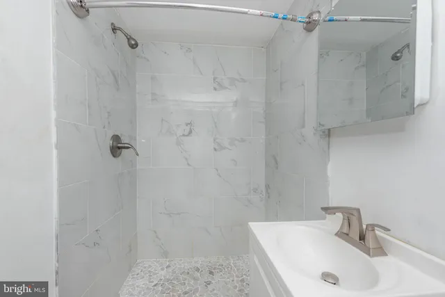 a bathroom with a sink and shower