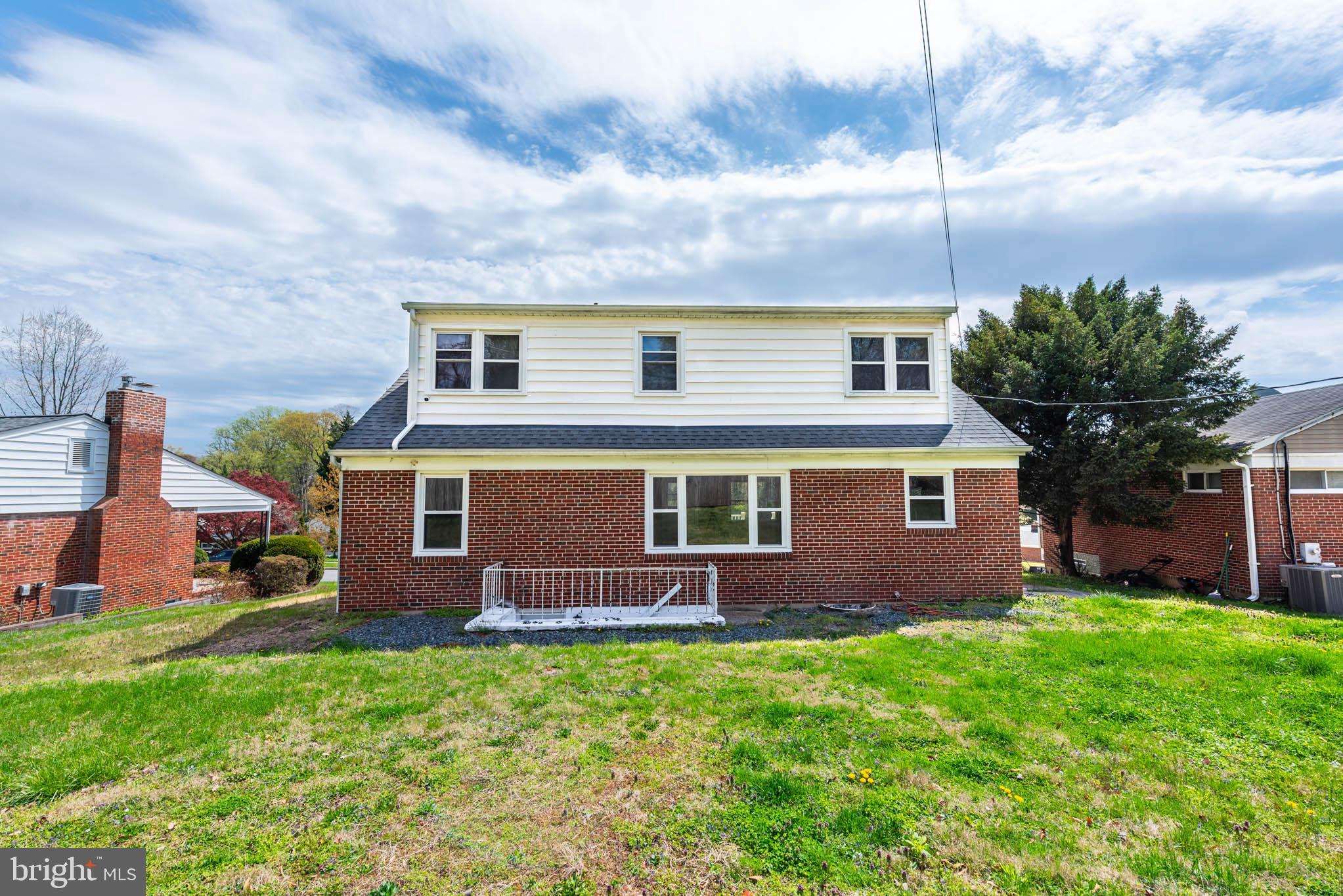 6702 Queens Ferry Road Baltimore, MD 21239 - Photo 36 of 40 a front view of a house with garden