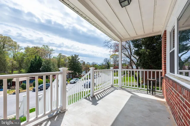 a view of a deck with a floor to ceiling window and wooden fence