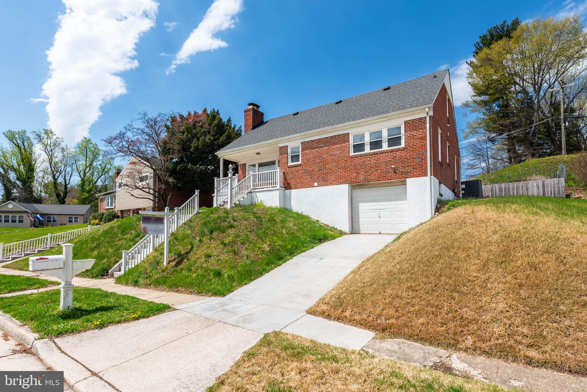6702 Queens Ferry Road Baltimore, MD 21239 - Photo 39 of 40 a front view of a house with garden