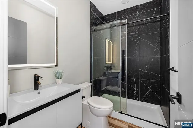 a bathroom with a sink toilet and shower