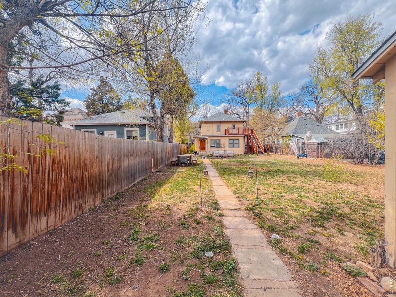 612 South Howes Street Fort Collins, CO 80521 - Photo 3 of 18 a view of a yard with a house in the background