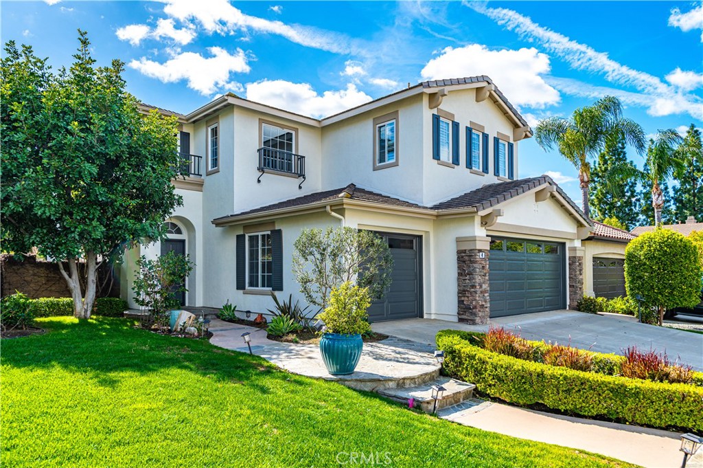 4 Whispering Pine Irvine, CA 92620 - Photo 3 of 12 a front view of a house with a yard and porch