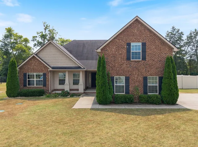 a front view of a house with a yard and garage