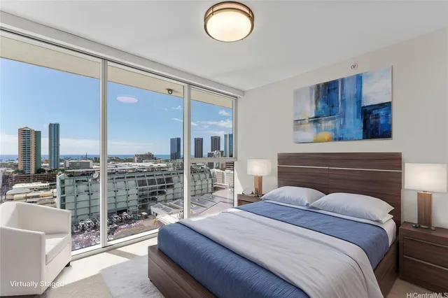 a bedroom with a large bed and a chandelier