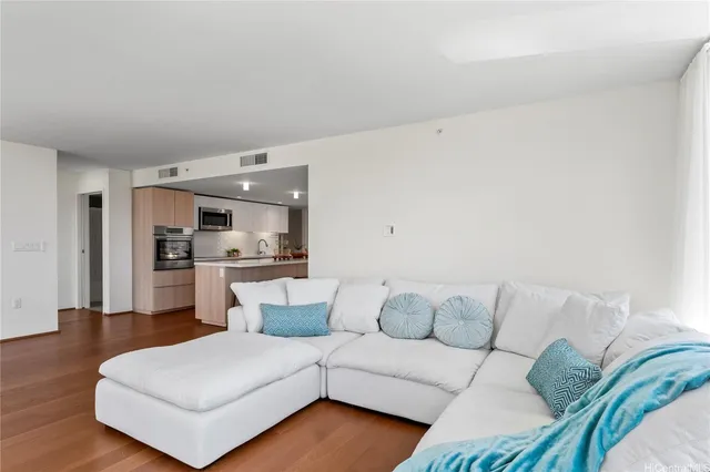 a living room with furniture and kitchen view